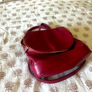 Very gently used mini backpack purse. Deep red.